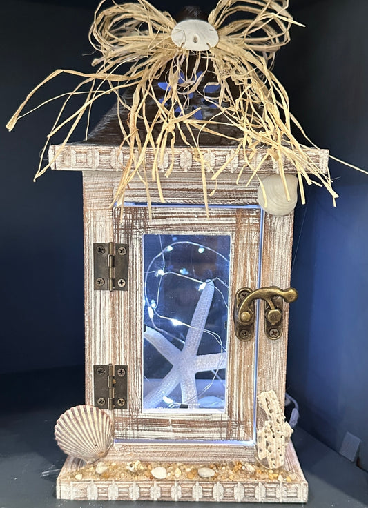 Beach-inspired lantern with sand, shells, and starfish, Jersey Shore home decor