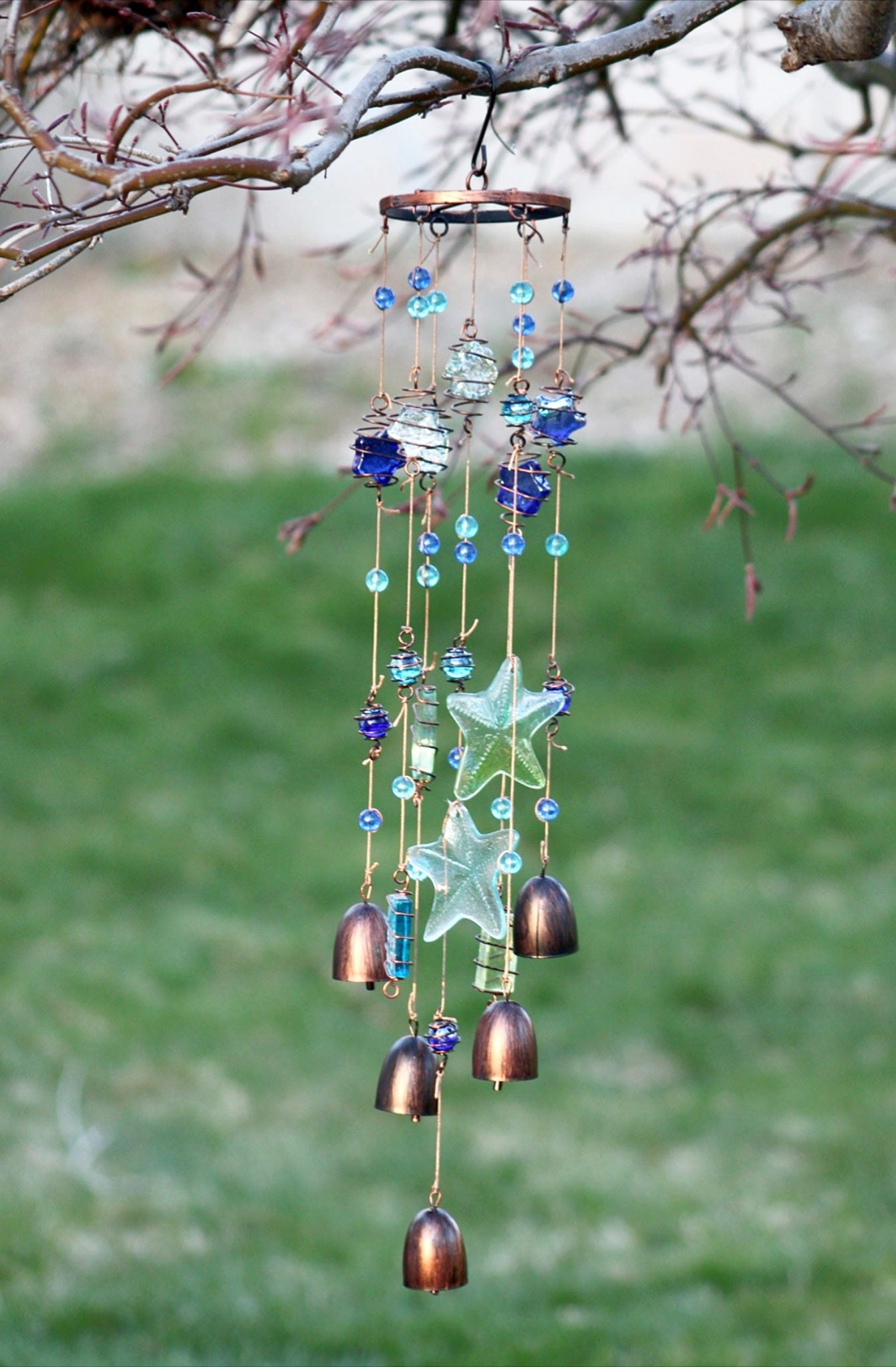 Handcrafted starfish wind chime with glass and metal bells, coastal patio decor